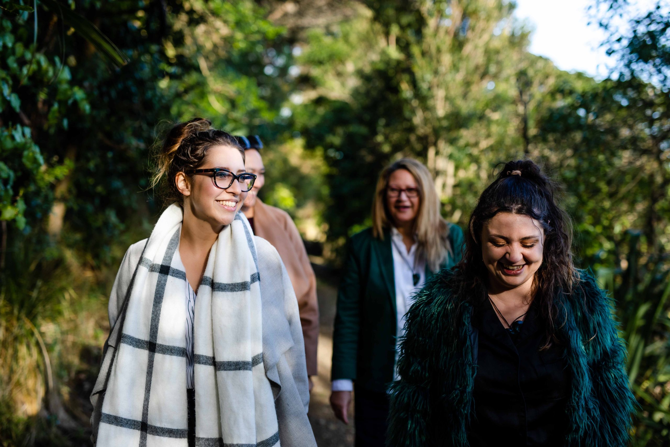 Māori women walk through the New Zealand bush.